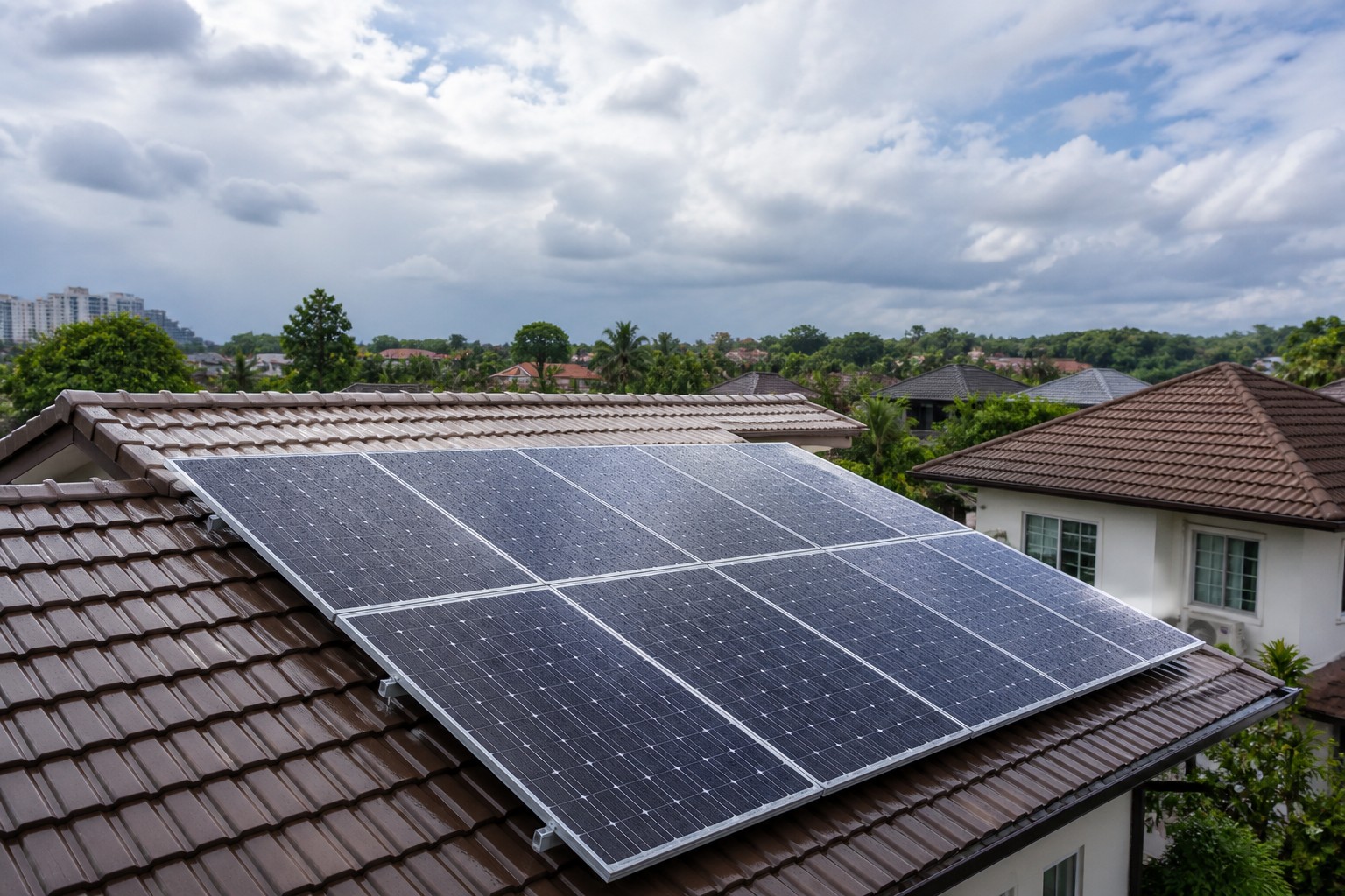 Solar panels on a Malaysian home under a cloudy sky